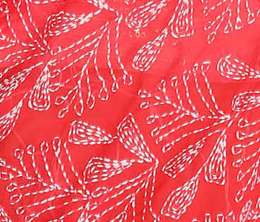White floral pattern on a red fabric background