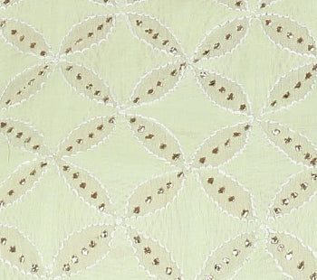 Close-up of a quilt with a diamond pattern on a light green background