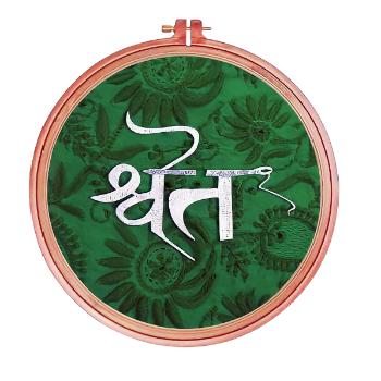 Decorative embroidery hoop with green fabric and white embroidered design on a white background