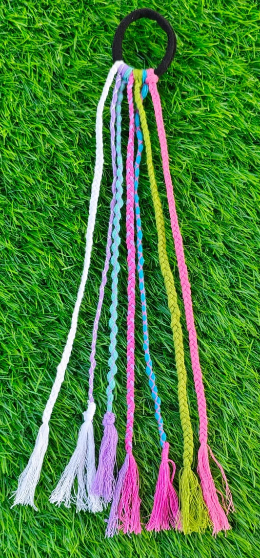 Colorful braided hair tie on a grass background