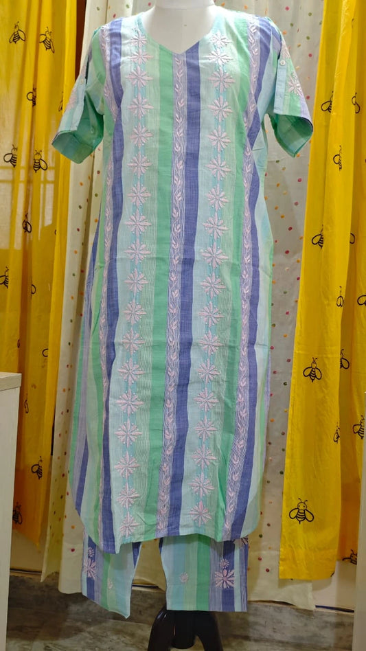Green and blue patterned kurta & Pant set on a mannequin against a yellow curtain background