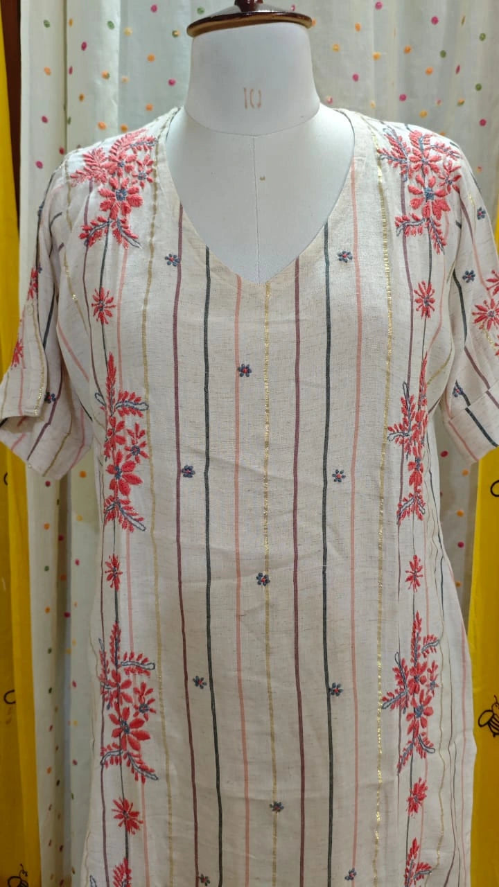 Mannequin wearing a Chikankari and striped dress with a white background