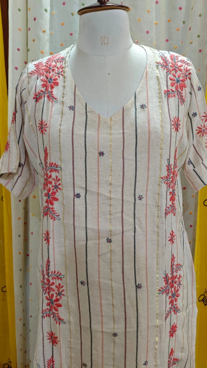 Mannequin wearing a Chikankari and striped dress with a white background