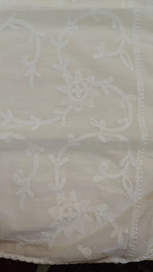 White   fabric with intricate patterns on a plain background