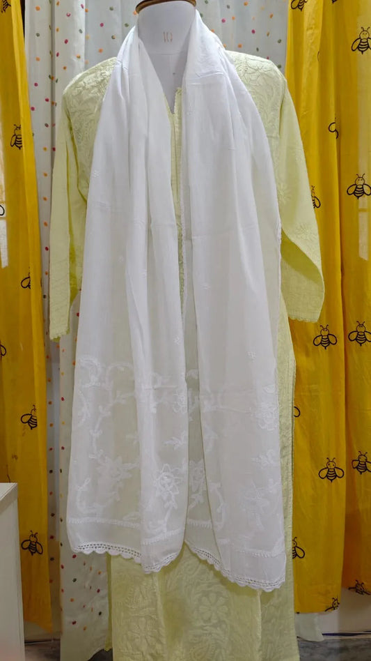White scarf draped over a mannequin with a yellow background
