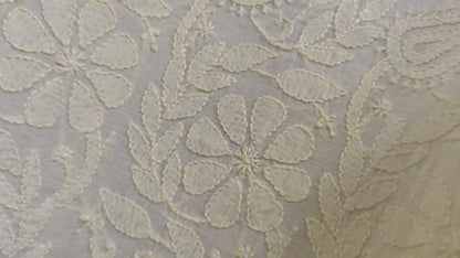 Close-up of Bakhiya chikankari embroidery  on  fabric with a light color on a white background