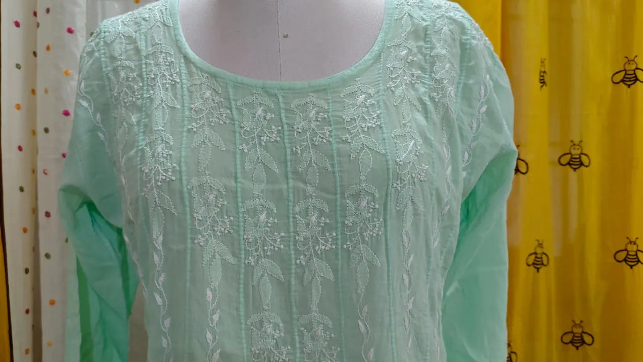 Light green top view on a mannequin with a colorful and patterned background