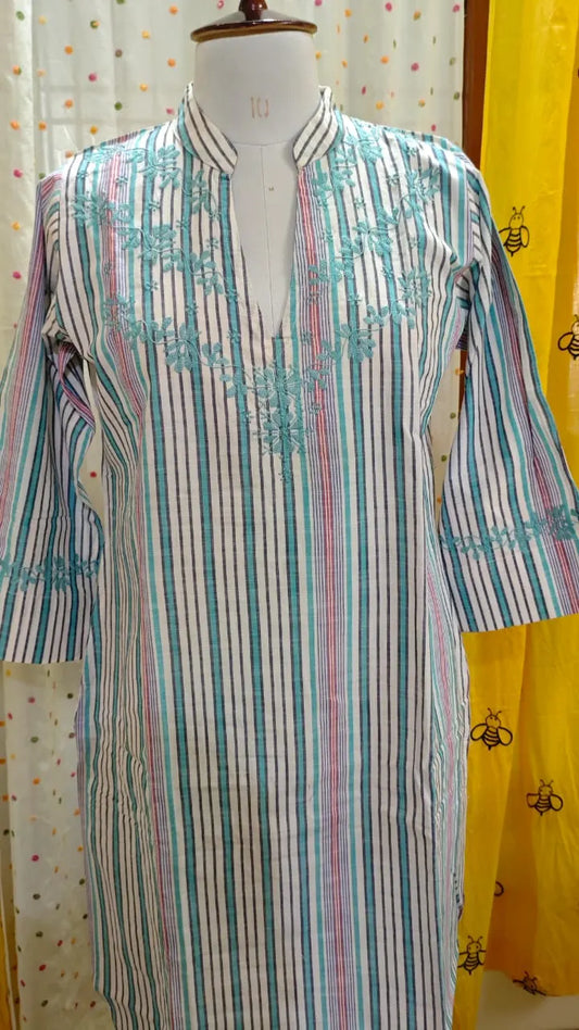 Multicolored striped Kurta on a mannequin against a patterned curtain background