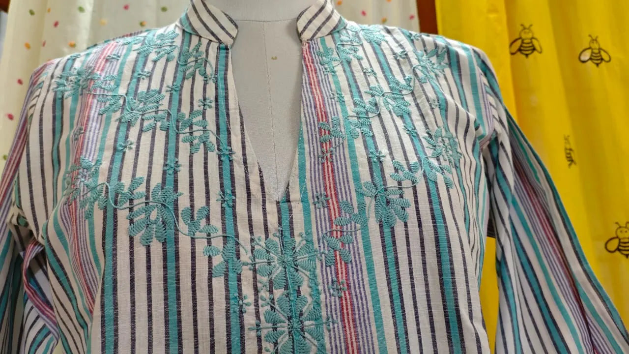 Striped Kurta with Hand  embroidery  Chikankari on a mannequin against a yellow background