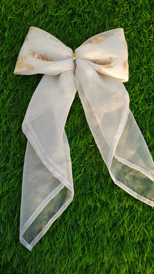 White sheer bow on green grass